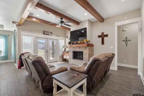 a living room with furniture a flat screen tv and a fireplace
