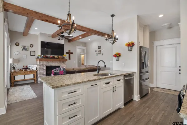 a kitchen with white cabinets and black appliances