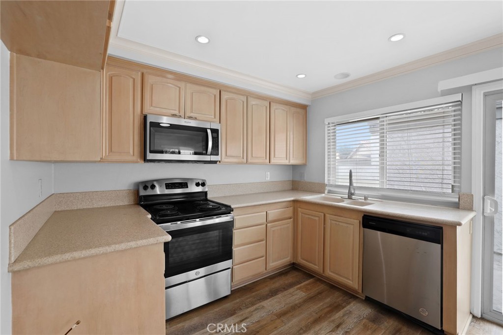 14452 Pimlico Road Westminster, CA 92683 - Photo 17 of 45 a kitchen with a sink stove and microwave