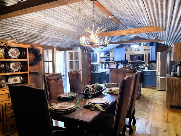a kitchen with refrigerator and chairs