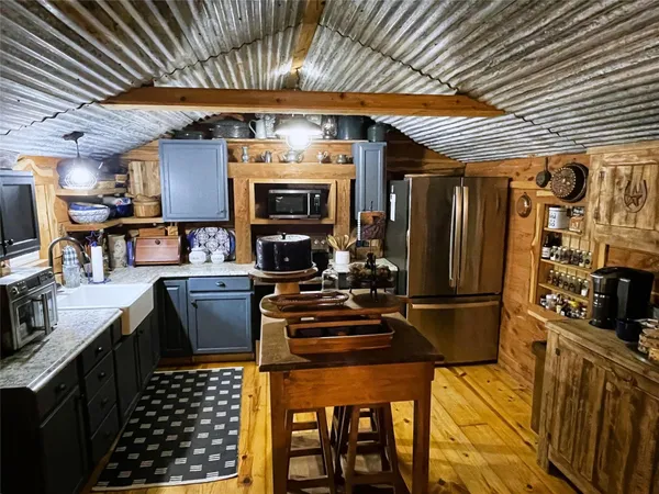 a kitchen with a sink a stove and cabinets
