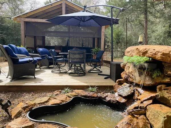 a view of a house with swimming pool and sitting area