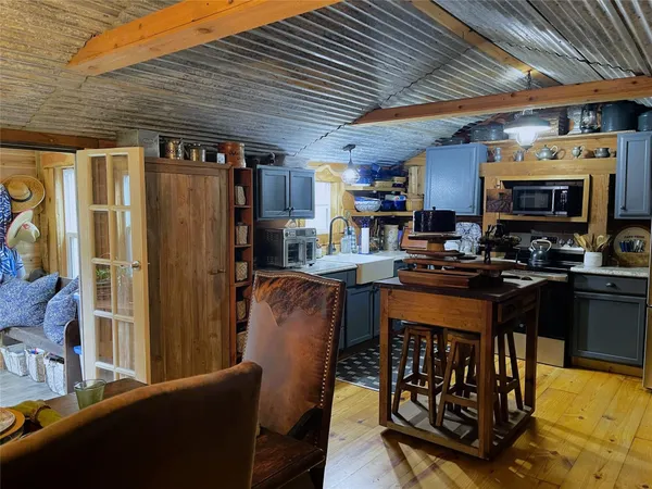 a kitchen with a refrigerator and a stove
