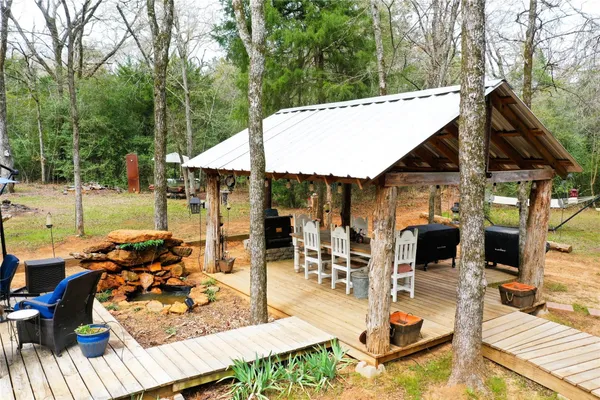 a view of the patio with couches chairs under an umbrella
