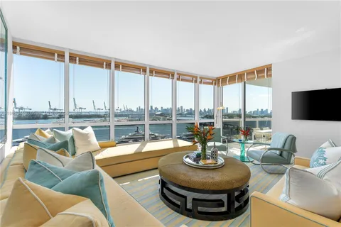 a living room with patio furniture and a flat screen tv