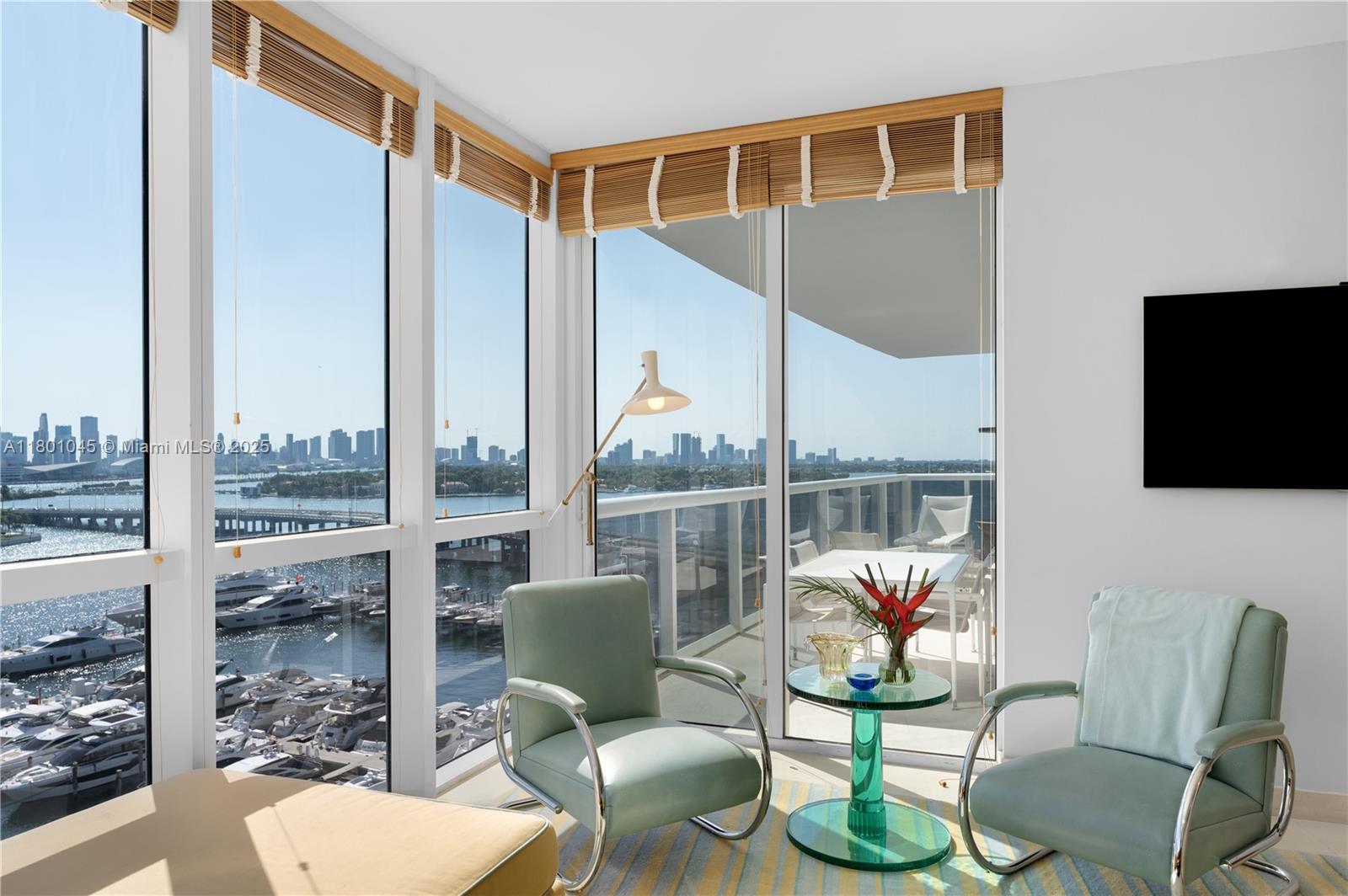 400 Alton Road, Unit 1101 Miami Beach, FL 33139 - Photo 15 of 31 a living room with patio furniture and a flat screen tv