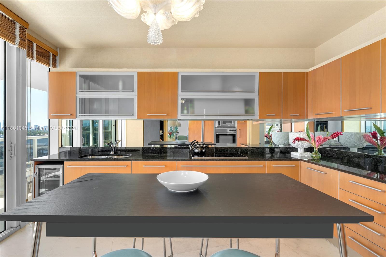 400 Alton Road, Unit 1101 Miami Beach, FL 33139 - Photo 18 of 31 a view of a kitchen with a large window and furniture