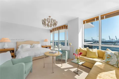 a balcony with furniture and a floor to ceiling window