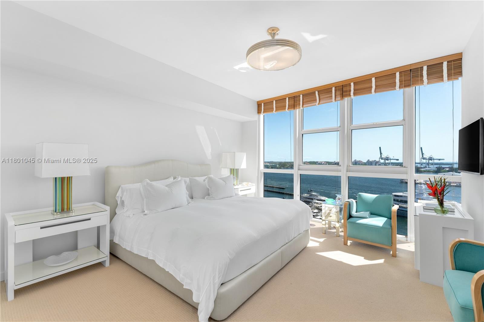 400 Alton Road, Unit 1101 Miami Beach, FL 33139 - Photo 24 of 31 a bedroom with a bed and a large window