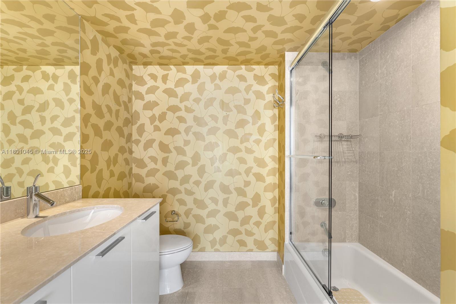 400 Alton Road, Unit 1101 Miami Beach, FL 33139 - Photo 25 of 31 a bathroom with a granite countertop sink toilet and shower