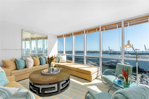 a large bedroom with a large bed and a large window