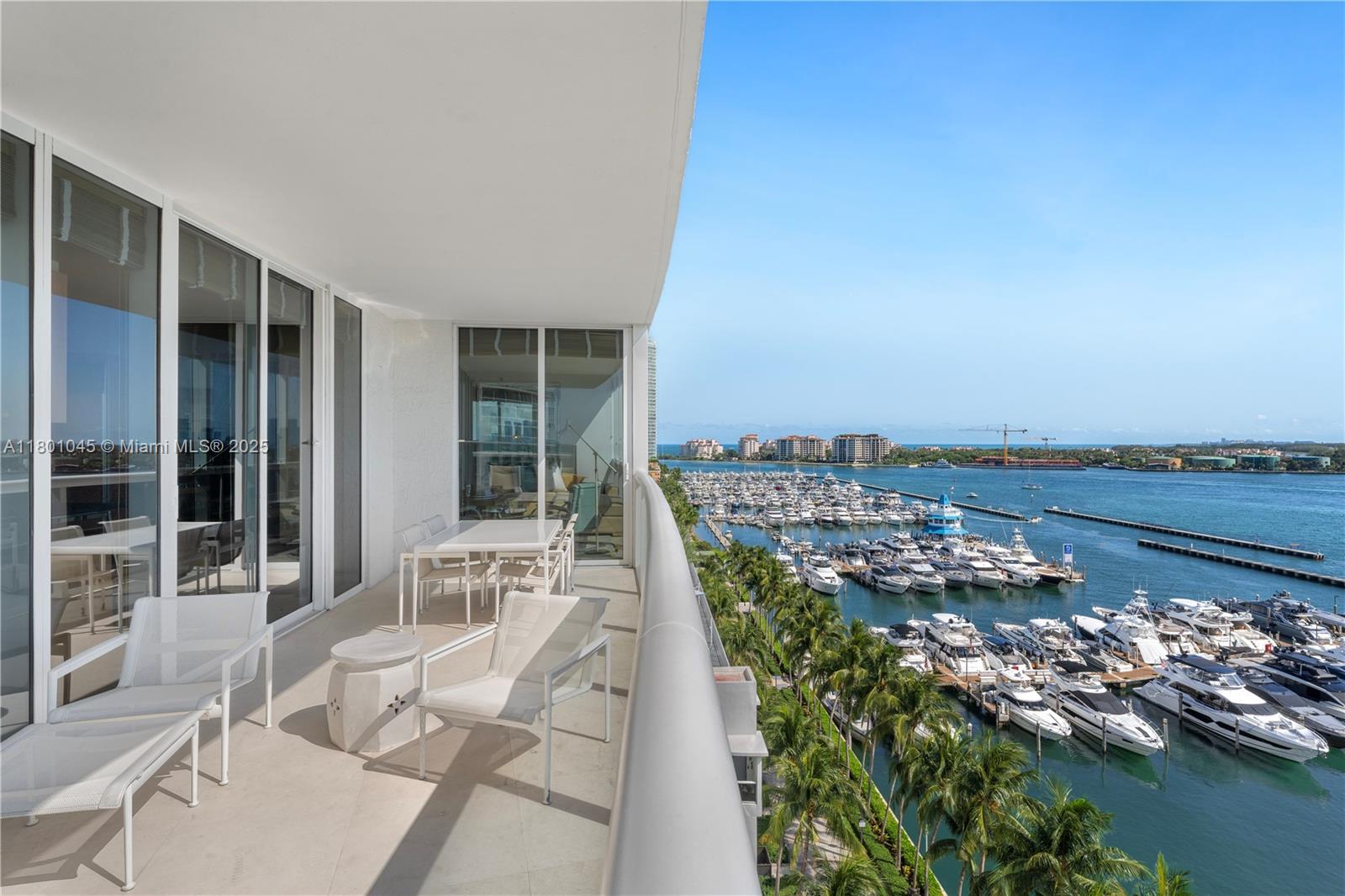 400 Alton Road, Unit 1101 Miami Beach, FL 33139 - Photo 9 of 31 a balcony with dining table and chairs