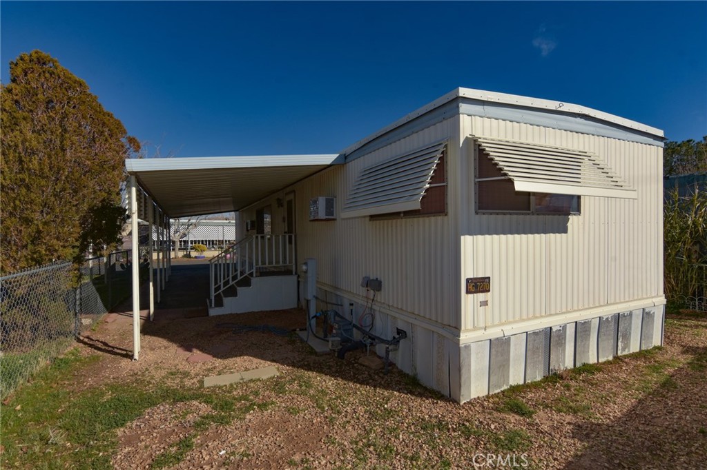 23456 Ottawa Road, Unit 4 Apple Valley, CA 92308 - Photo 15 of 17 a view of a house with a backyard