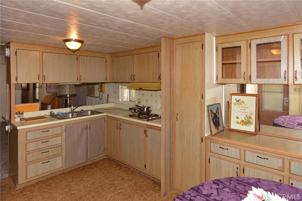 23456 Ottawa Road, Unit 4 Apple Valley, CA 92308 - Photo 6 of 17 a kitchen with a sink cabinets and window