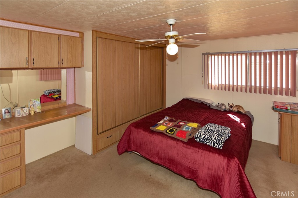 23456 Ottawa Road, Unit 4 Apple Valley, CA 92308 - Photo 10 of 17 a bed sitting in a bedroom next to a window