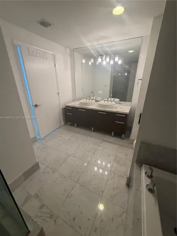 a bath tub sitting next to a shower