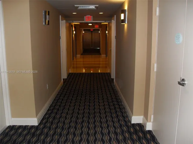 a living room with furniture a rug and kitchen view