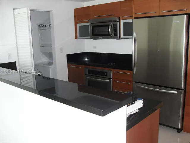 a view of living room with furniture and wooden floor