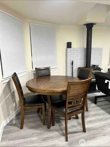 a dining room with furniture and wooden floor