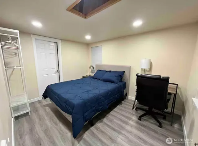 a bedroom with a bed and a desk