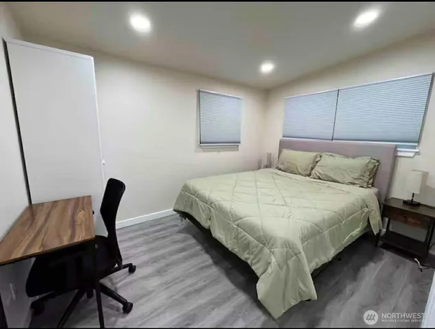 a bedroom with bed and a chair