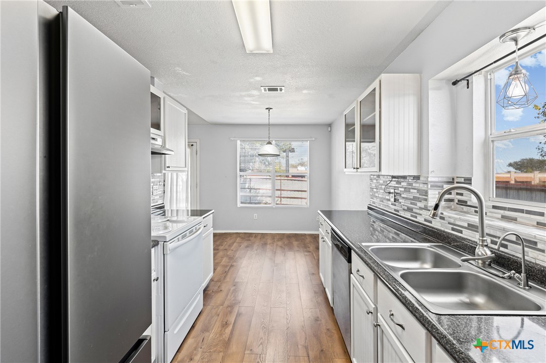 305 James Loop Killeen, TX 76542 - Photo 11 of 32 a kitchen with stainless steel appliances granite countertop a sink stove and refrigerator