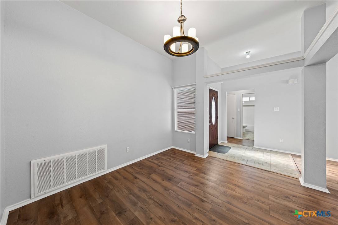 305 James Loop Killeen, TX 76542 - Photo 12 of 32 a view of a livingroom with wooden floor and a window