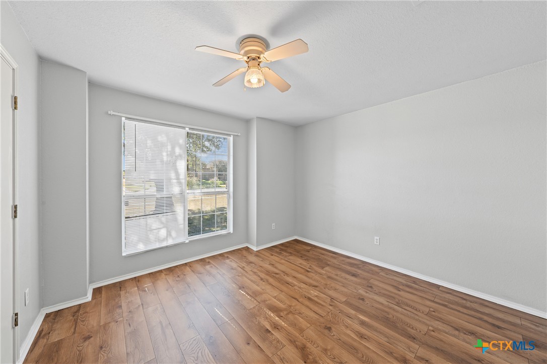 305 James Loop Killeen, TX 76542 - Photo 14 of 32 wooden floor in an empty room with a window