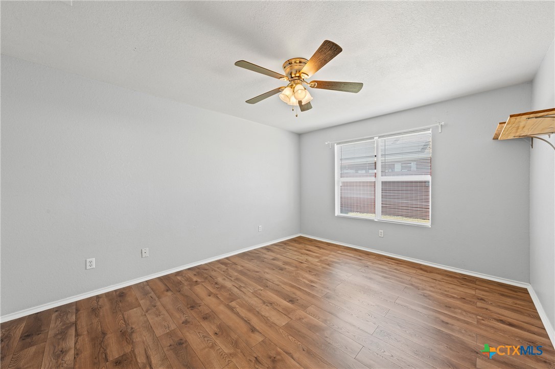 305 James Loop Killeen, TX 76542 - Photo 19 of 32 a view of empty room with wooden floor and fan
