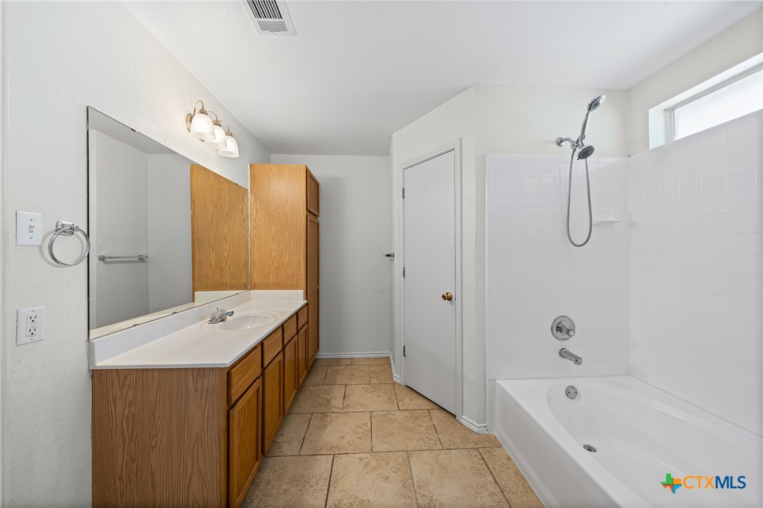 305 James Loop Killeen, TX 76542 - Photo 22 of 32 a bathroom with a tub sink shower and mirror