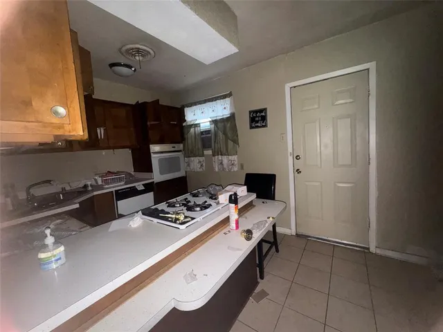 a kitchen with a sink appliances and cabinets