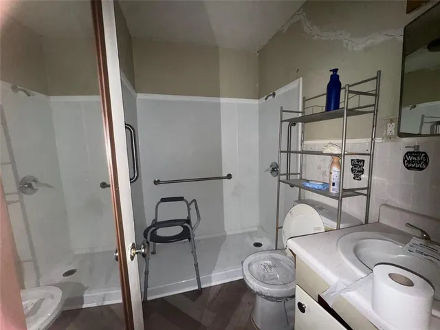 a bathroom with a sink toilet and shower