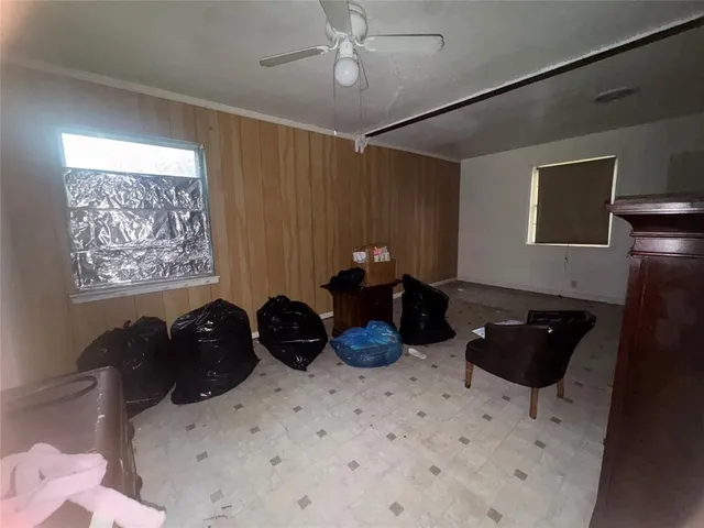 a room with a chandelier furniture and a potted plant