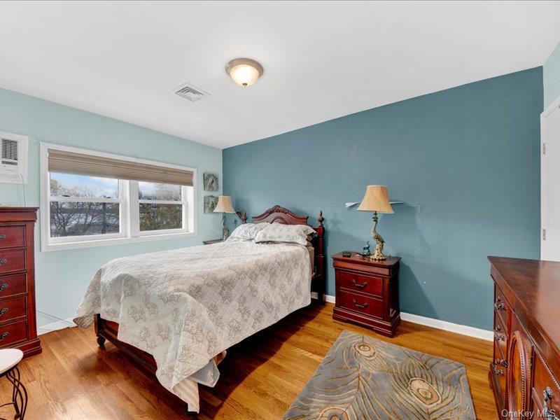2576 Harding Avenue Bronx, NY 10465 - Photo 16 of 26 a bedroom with a bed and wooden floor
