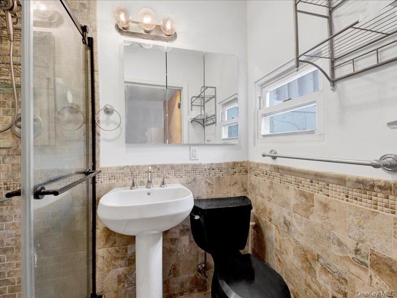 2576 Harding Avenue Bronx, NY 10465 - Photo 19 of 26 a bathroom with a sink and a mirror