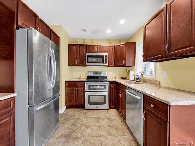 2576 Harding Avenue Bronx, NY 10465 - Photo 9 of 26 a kitchen with stainless steel appliances granite countertop a refrigerator stove and microwave