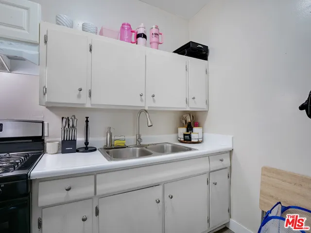 a kitchen with cabinets appliances and a sink