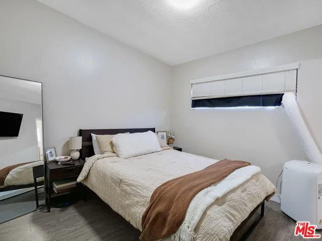 a bedroom with a bed and a television