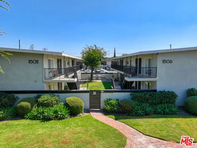 a front view of a house with swimming pool having outdoor seating