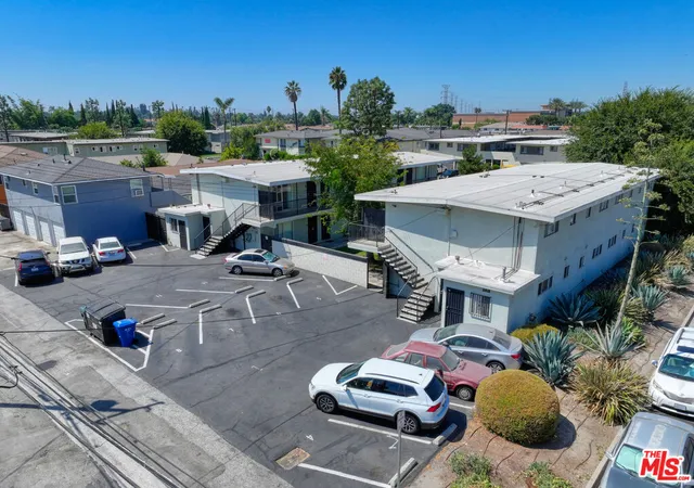 a view of a patio with table and chairs potted plants with sky view