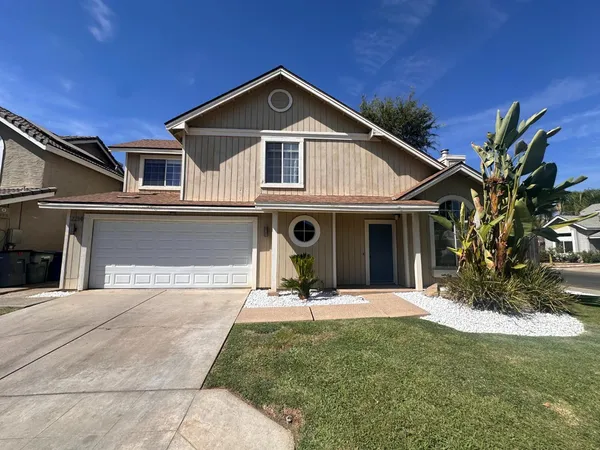 a front view of a house with a yard