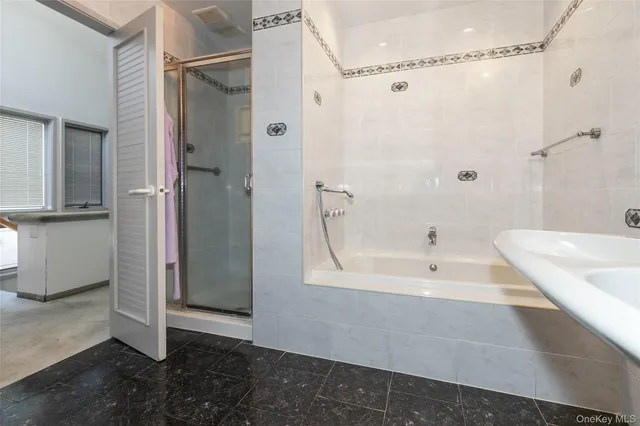 a bathroom with a bathtub and a shower