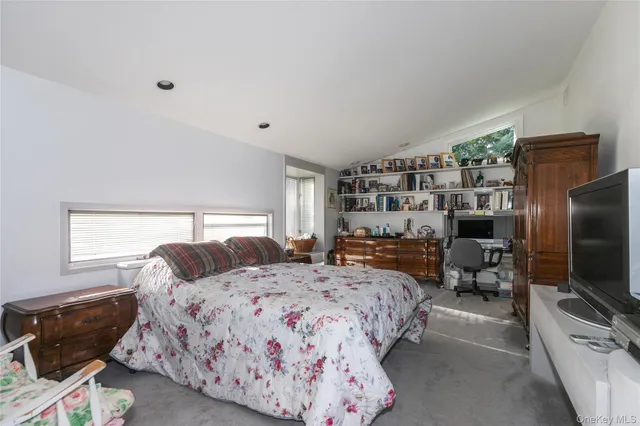 a bedroom with a bed and a television