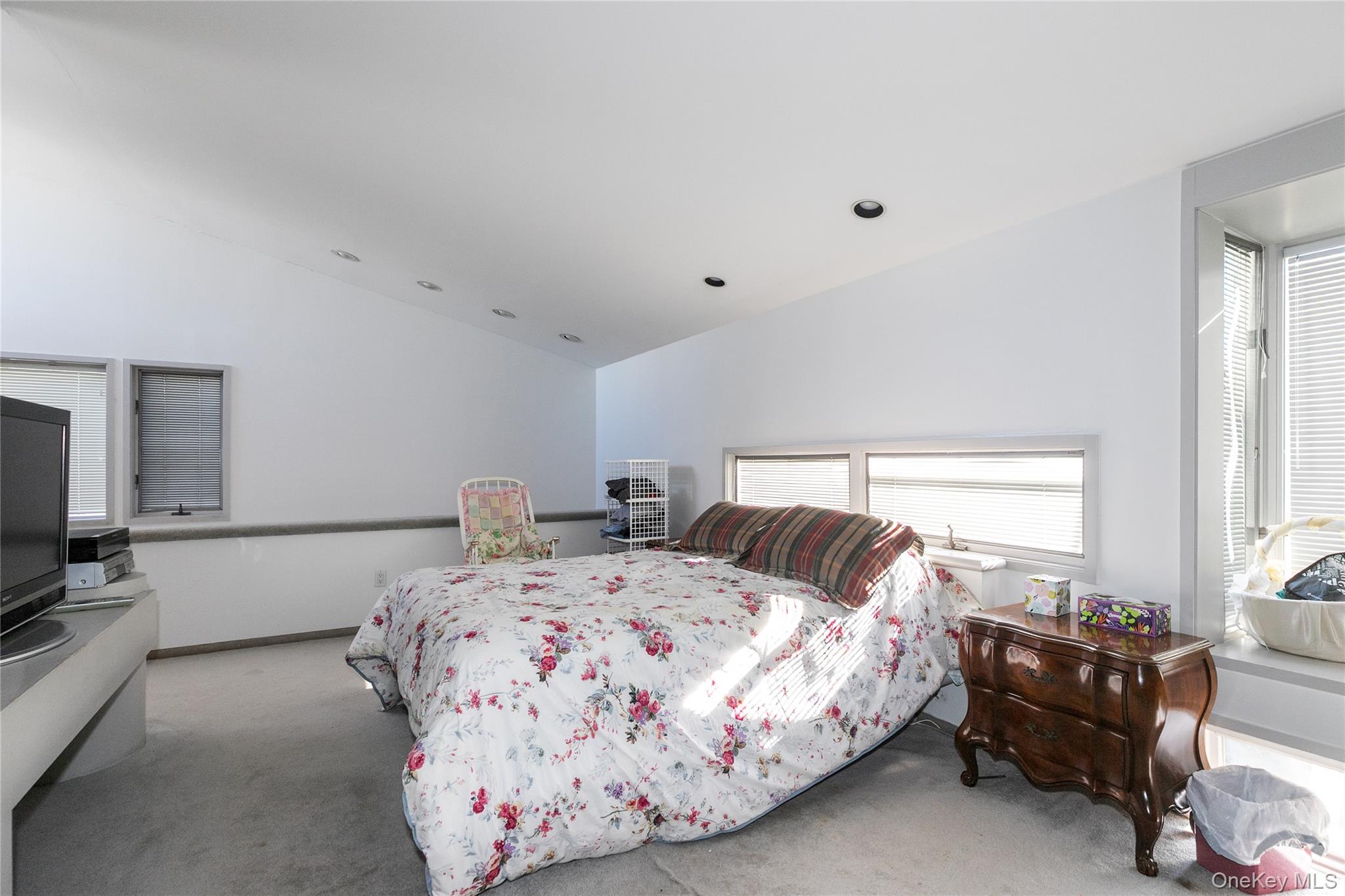 1 Franklin Road Great Neck, NY 11024 - Photo 19 of 30 a bedroom with a bed and a couch