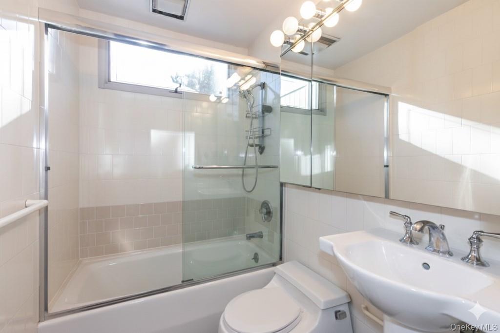 1 Franklin Road Great Neck, NY 11024 - Photo 20 of 30 a bathroom with a shower sink vanity mirror and toilet