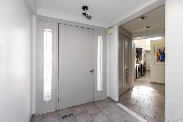 a view of a hallway with wooden shelves