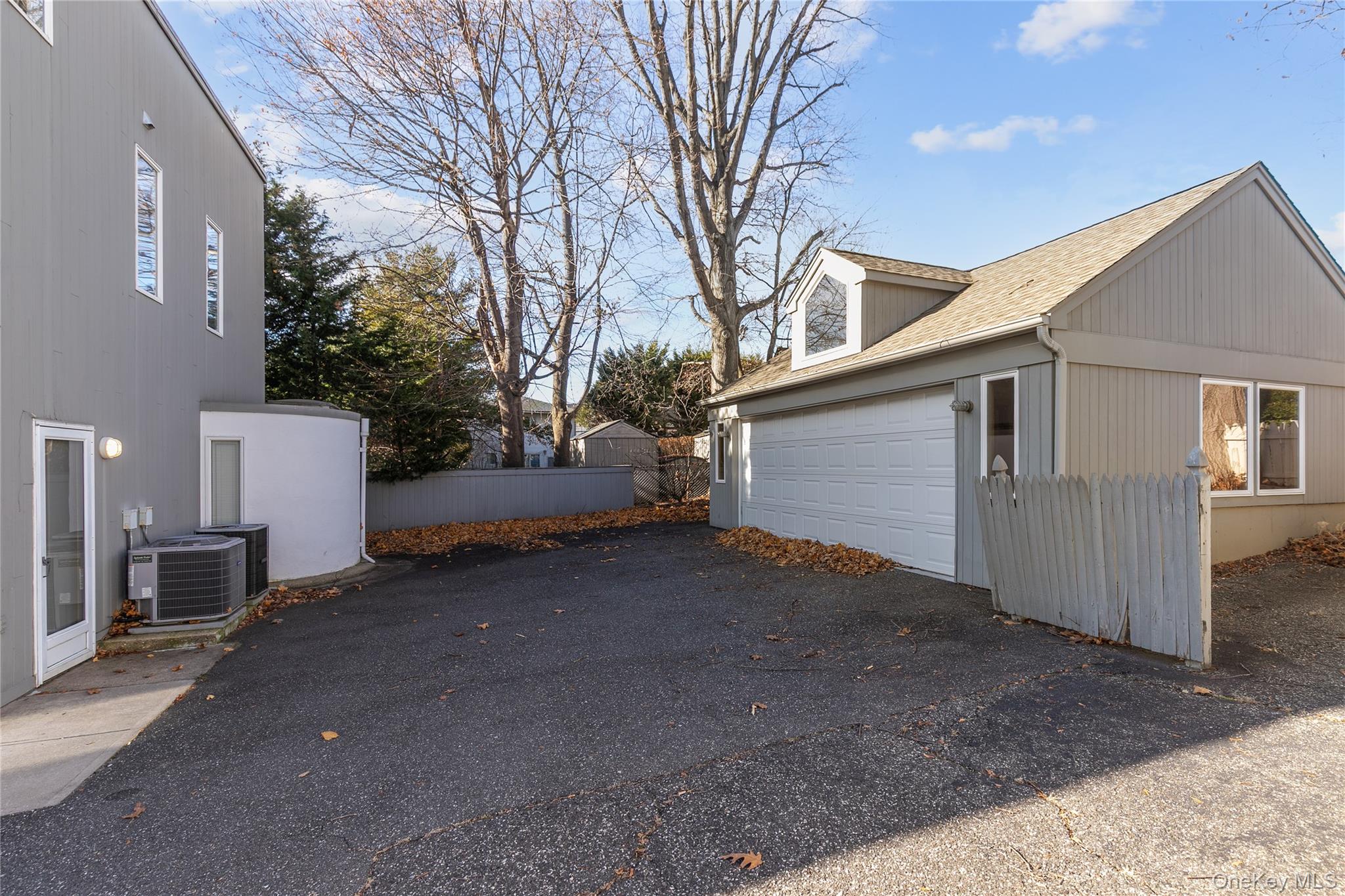 1 Franklin Road Great Neck, NY 11024 - Photo 24 of 30 a view of a house with a yard and garage