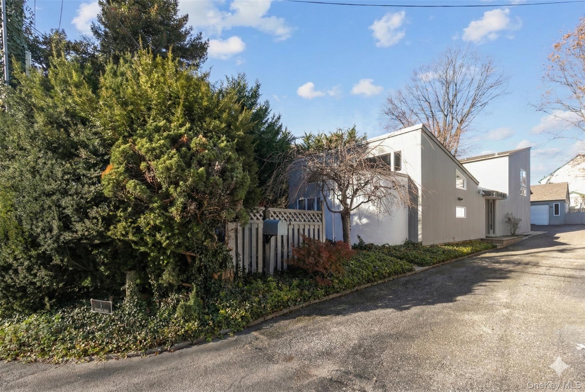 1 Franklin Road Great Neck, NY 11024 - Photo 25 of 30 a view of a house with a small yard and large tree