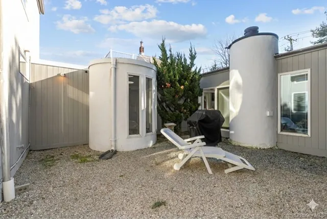 a white building with a sink and a yard