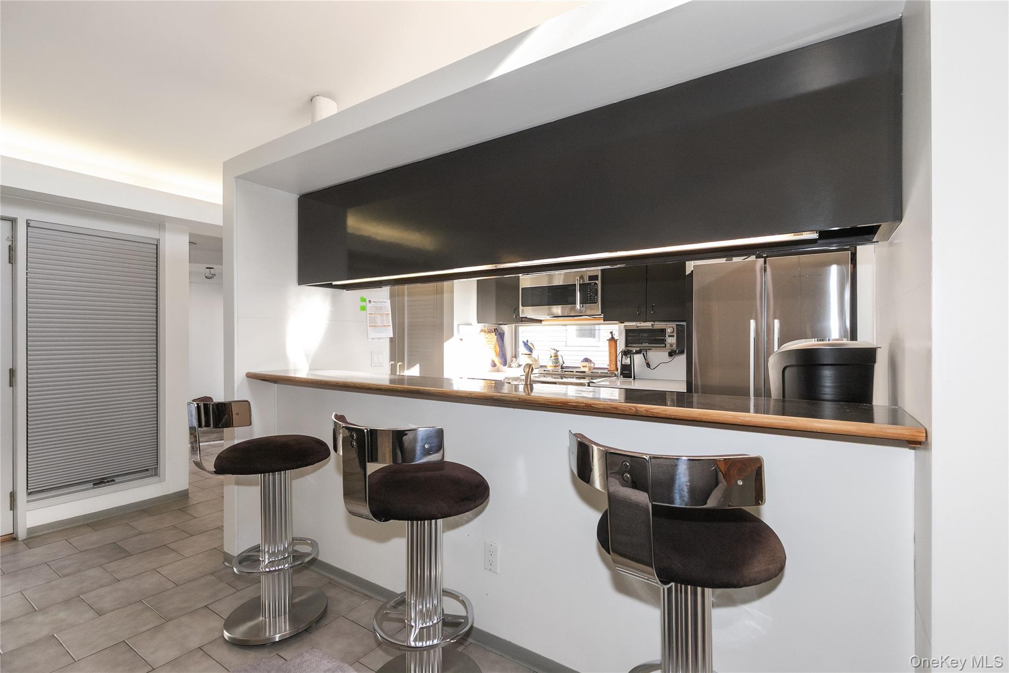 1 Franklin Road Great Neck, NY 11024 - Photo 9 of 30 a kitchen with a sink and chairs